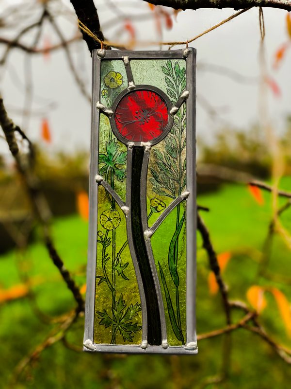Stained glass image of a Rememebrance Day Poppy